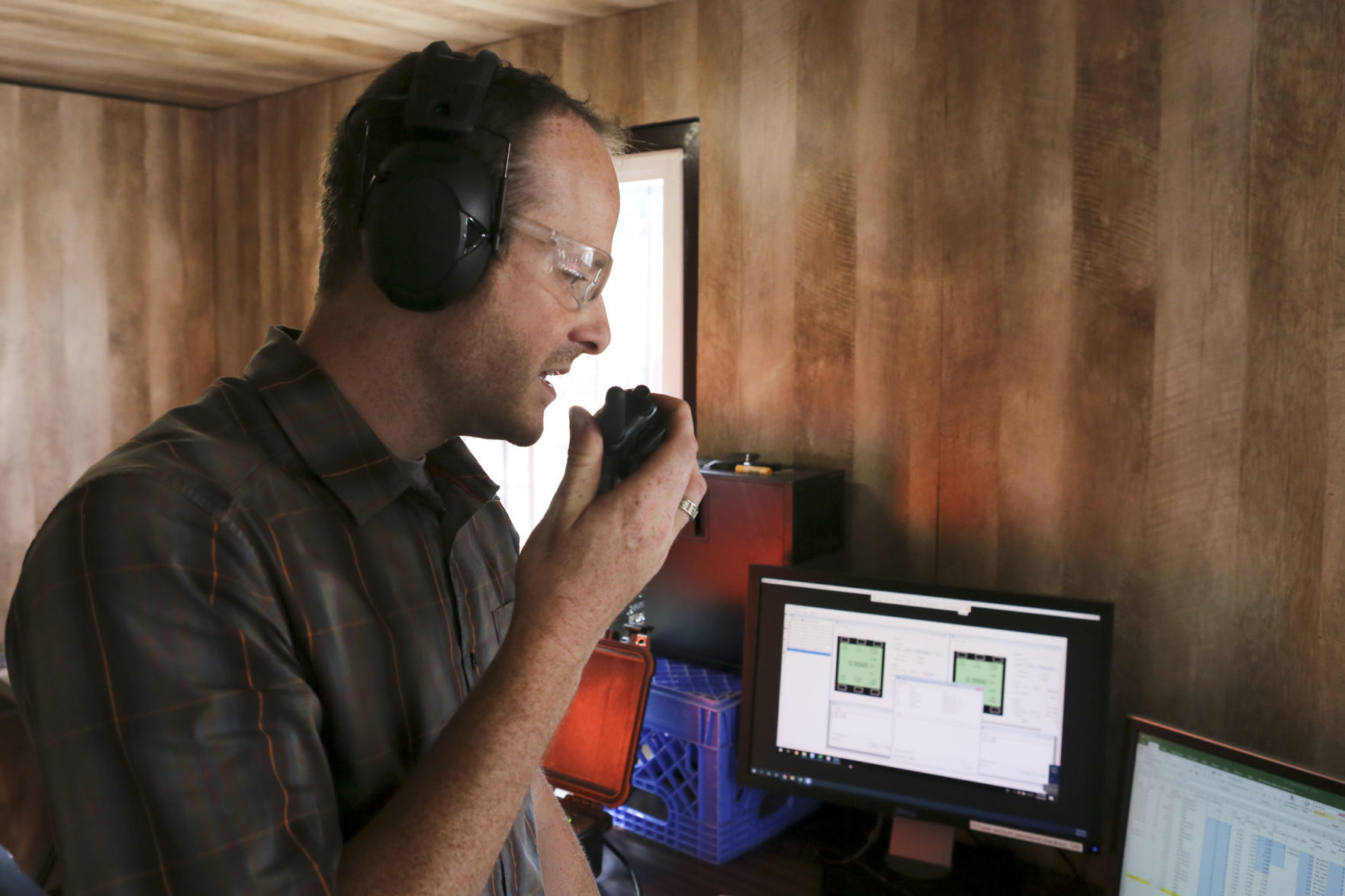 Eric Jacques checks in by radio with his safety team prior to firing the shock tube